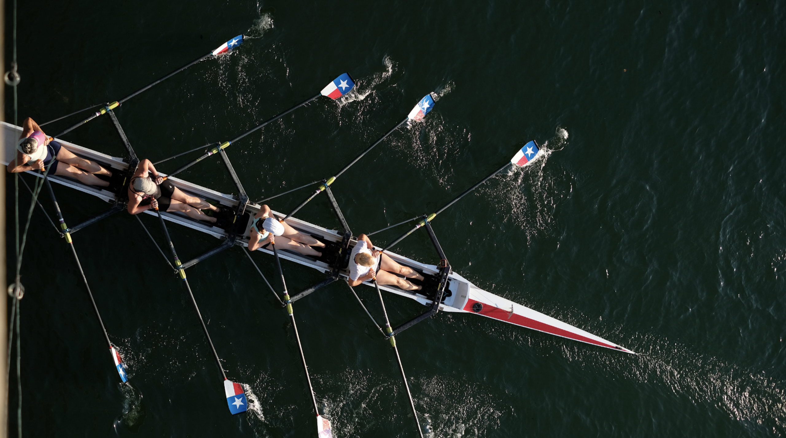 photo of a team rowing a boat