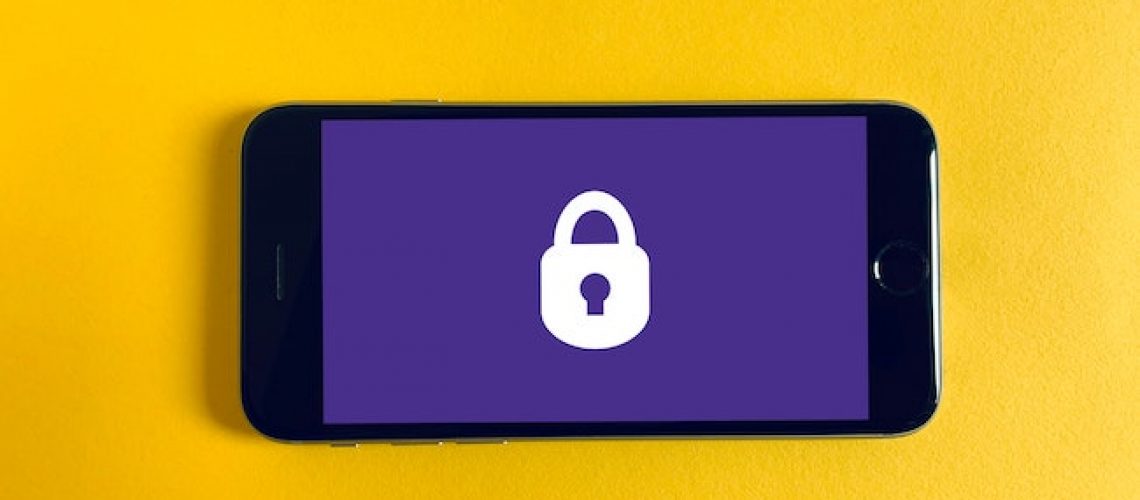 photo of a mobile phone with a security icon lock on the screen